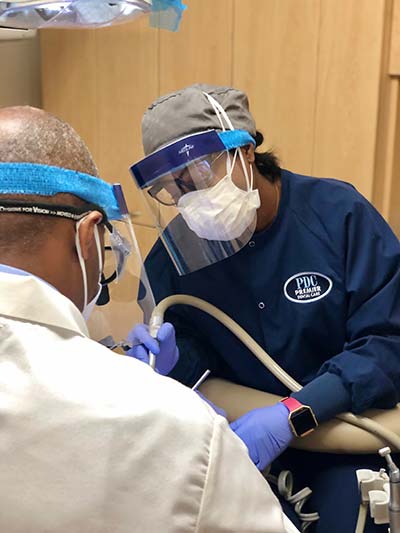 Dr. Hines and dental hygienist performing a restorative dental procedure in Washington, DC