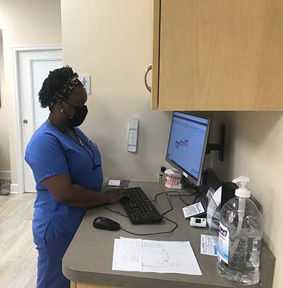 dental hygienist inputting new patient information