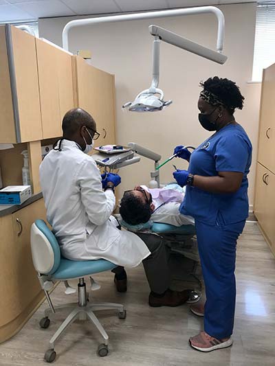Dr. Hines cleaning a patient's teeth