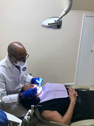 Dr. Hines performing a cosmetic dentistry procedure on patient